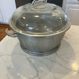 Dutch oven with metal bottom and glass top.  The brand is Guardian Service